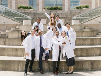 Group of smiling people in white coats
