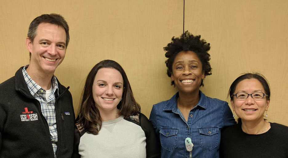 four people posing for a photo
