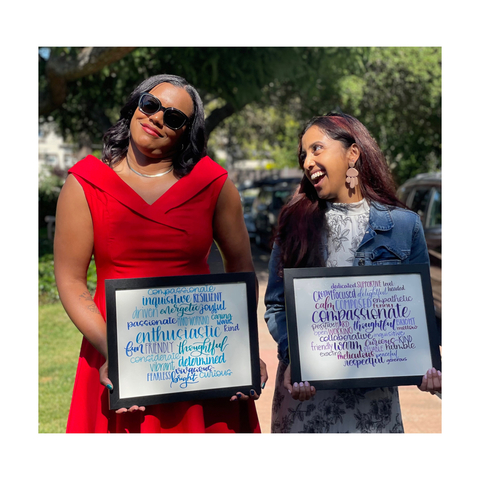 Two people posing for a photo holding their award certificates
