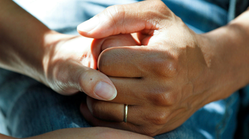 Patient holds hands with caregiver