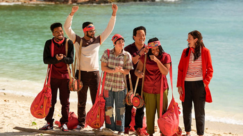 Group of people posing for a photo on a beach