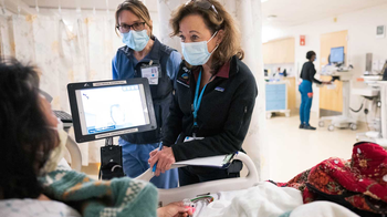 Two Nurse Practitioners talking to a patient