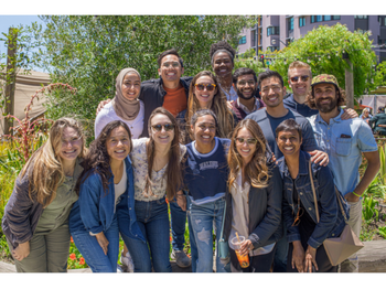 a group of people posing for a photo outside