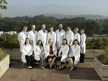 Group of graduates in their white coats for their graduation