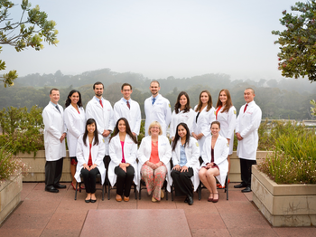 Group in their white coats posing for graduation photo