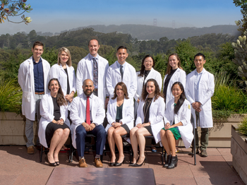 Group photo of graduates in their white coats