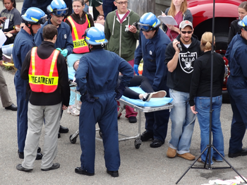 Group of medical people running a simulation of a medical issue around a patient